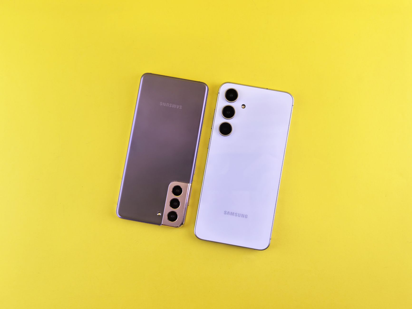Pair of modern smartphones displayed on a vibrant yellow background highlighting sleek design.
