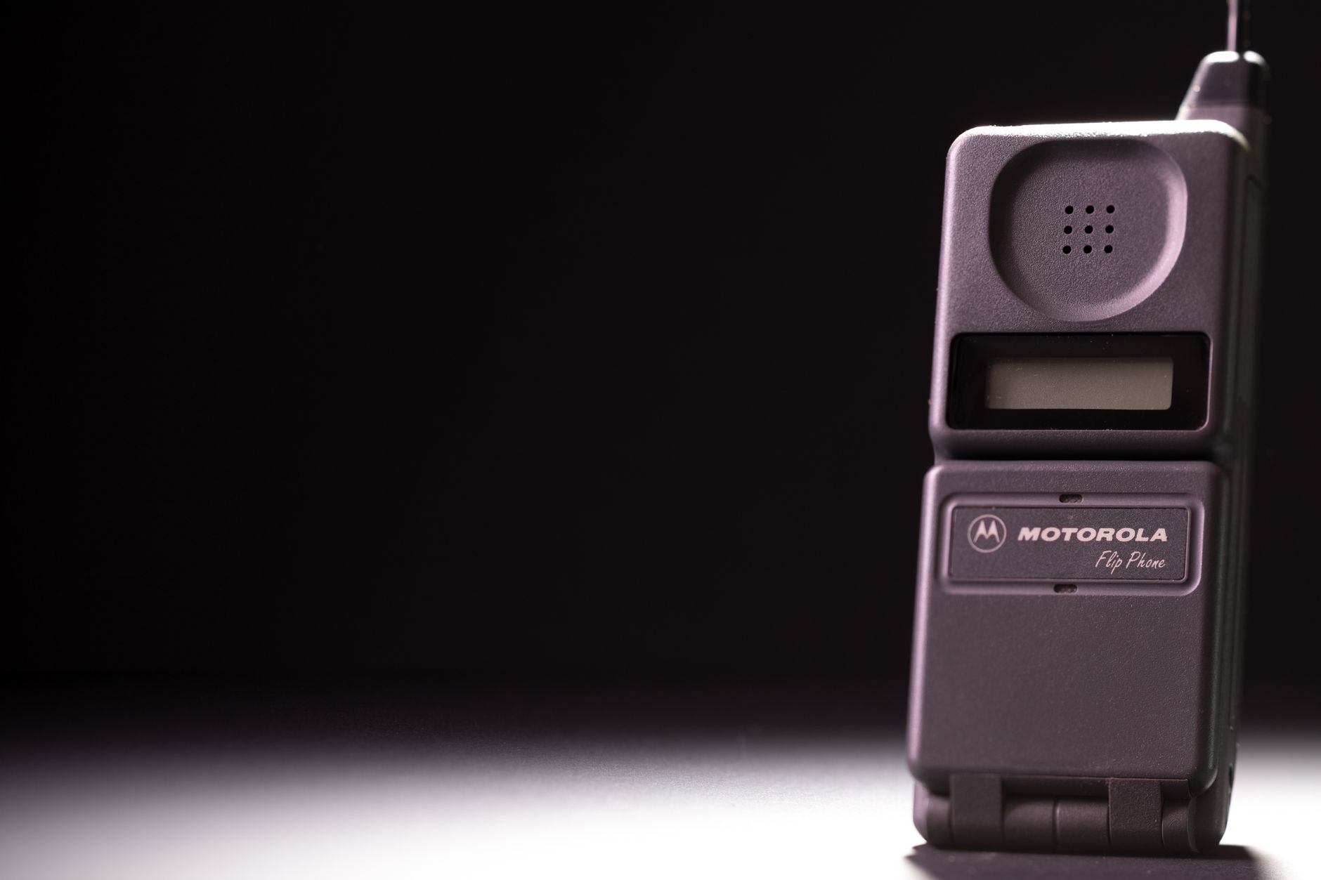 Classic Motorola flip phone on a dark background, highlighting its retro charm.