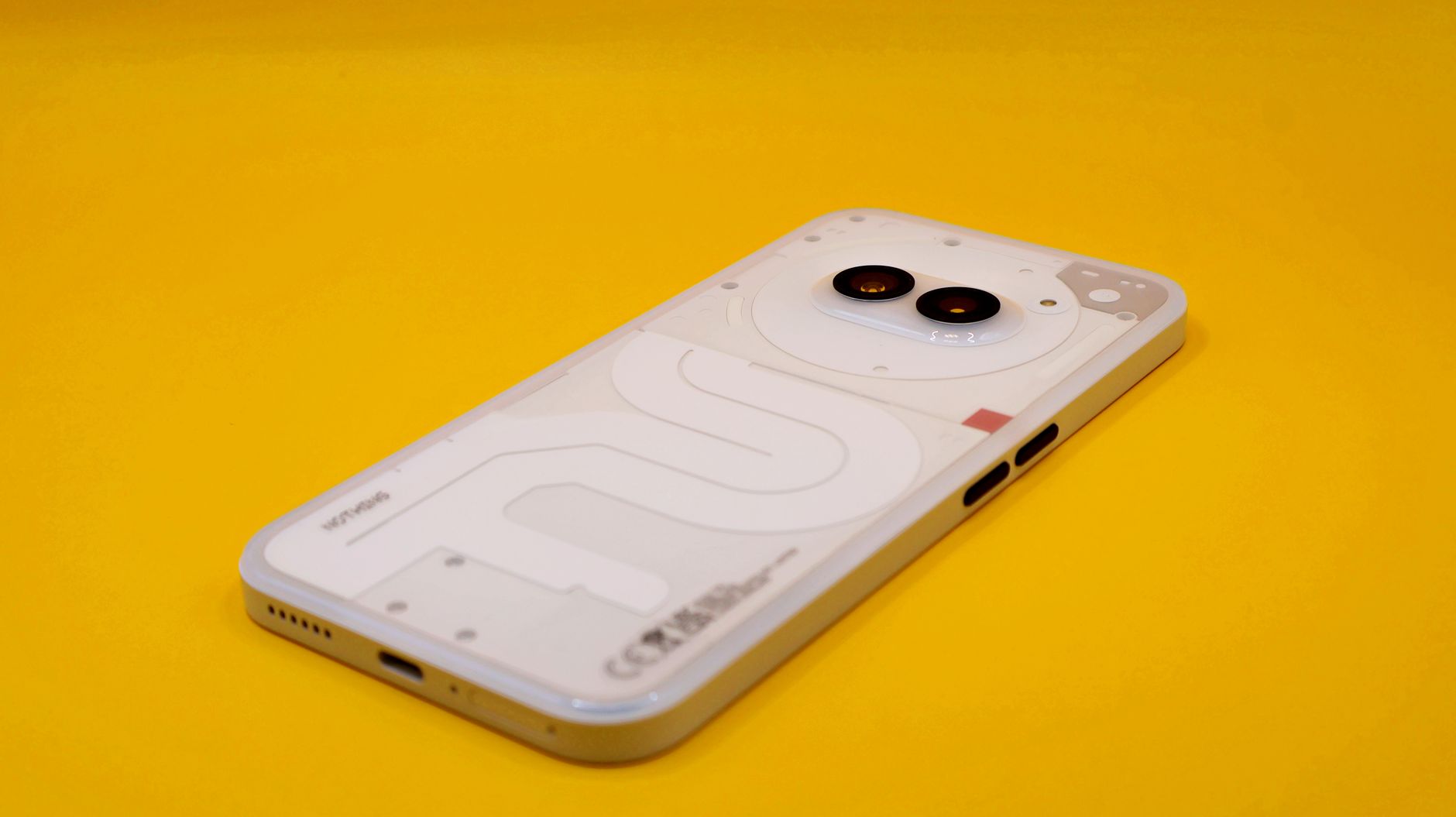 A modern smartphone with dual cameras on a vivid yellow background. Minimalist tech vibe.