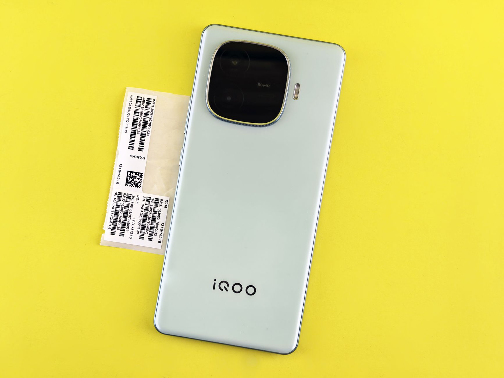 Modern smartphone displayed on a vibrant yellow surface, showcasing sleek design.