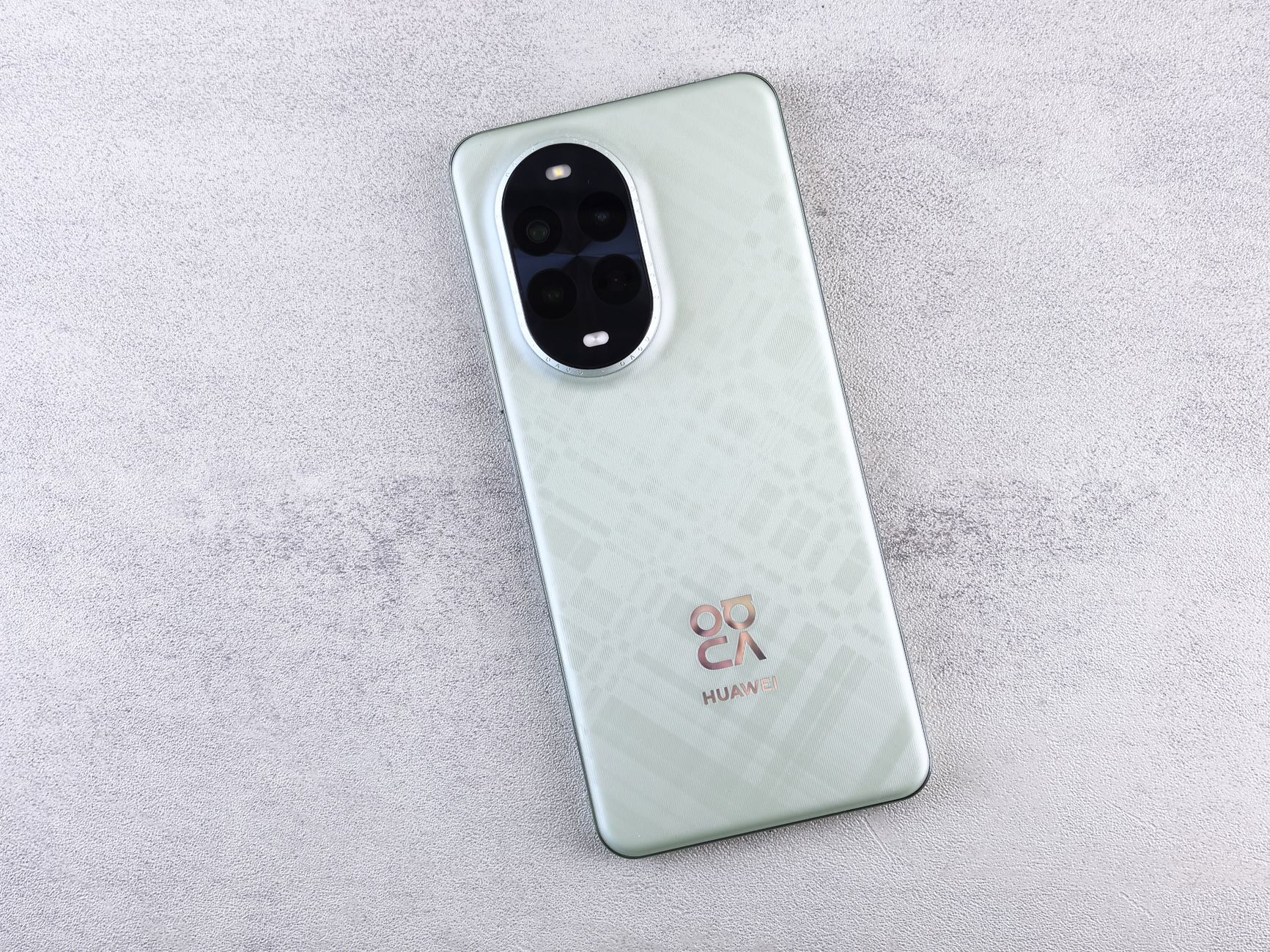 Modern smartphone with quad-camera setup displayed on a textured background for tech enthusiasts.
