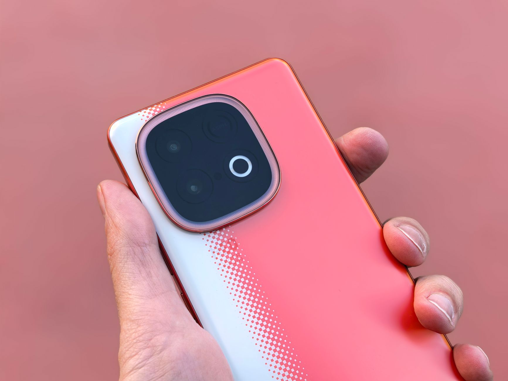 Close-up of a modern smartphone held in hand, highlighting back design and camera details.
