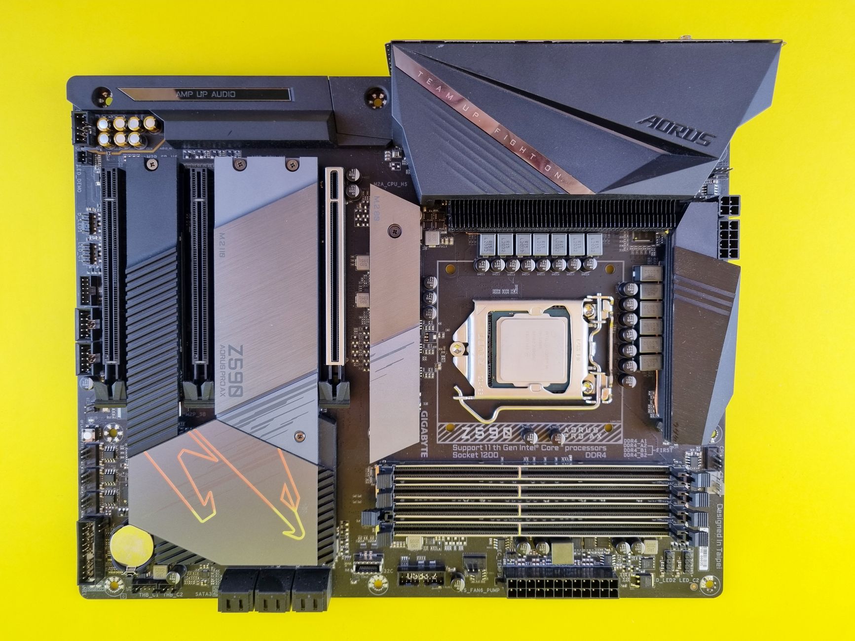 Close-up of a high-performance Aorus motherboard with vibrant yellow background, ideal for tech enthusiasts.