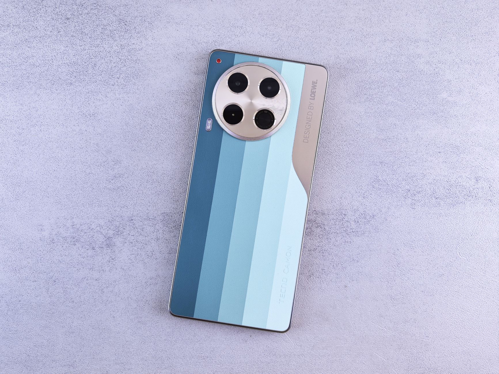 Close-up of a modern smartphone featuring a circular camera module on a textured surface.