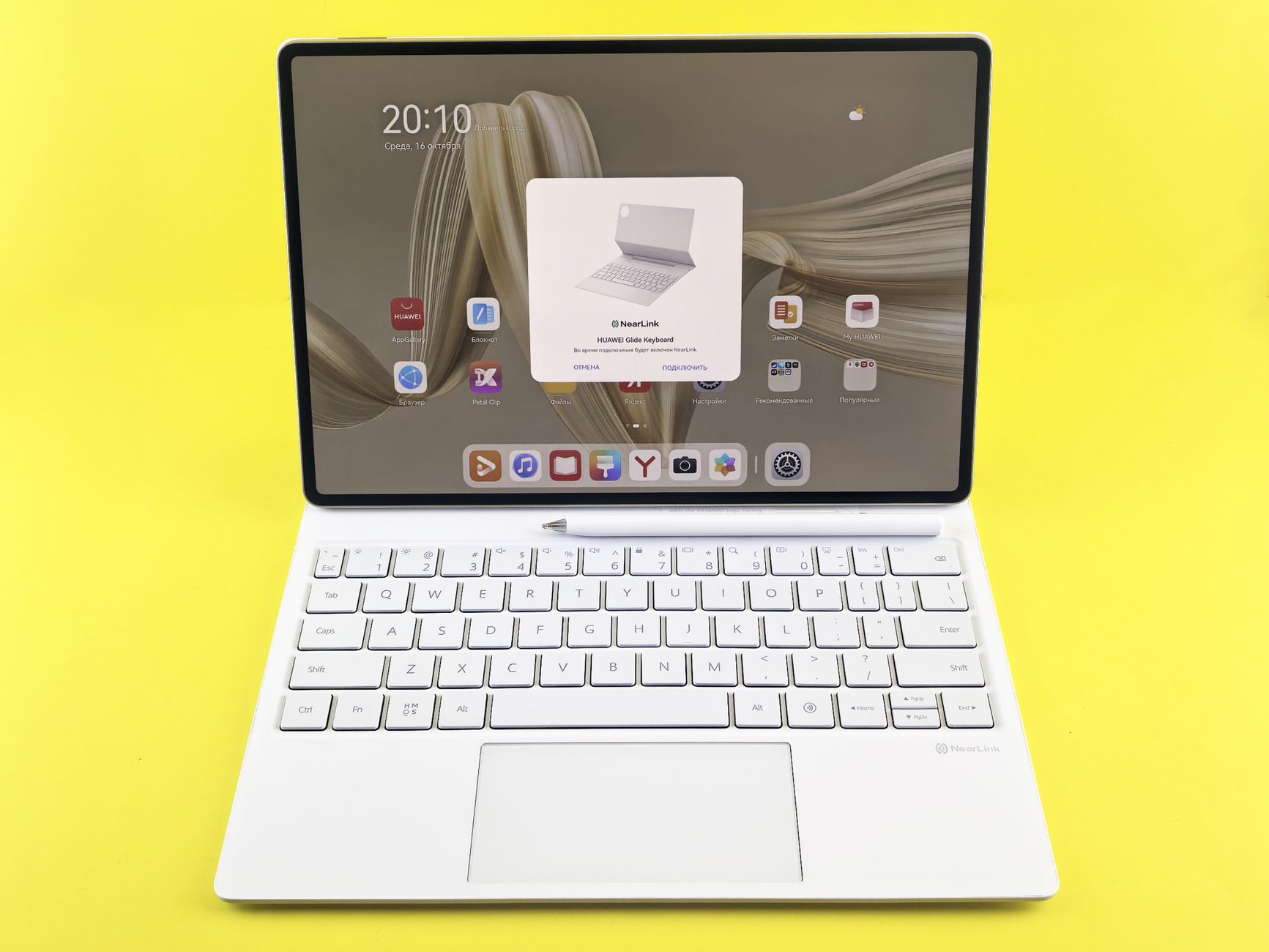 Sleek tablet with detachable keyboard on a vibrant yellow background, demonstrating cutting-edge technology.
