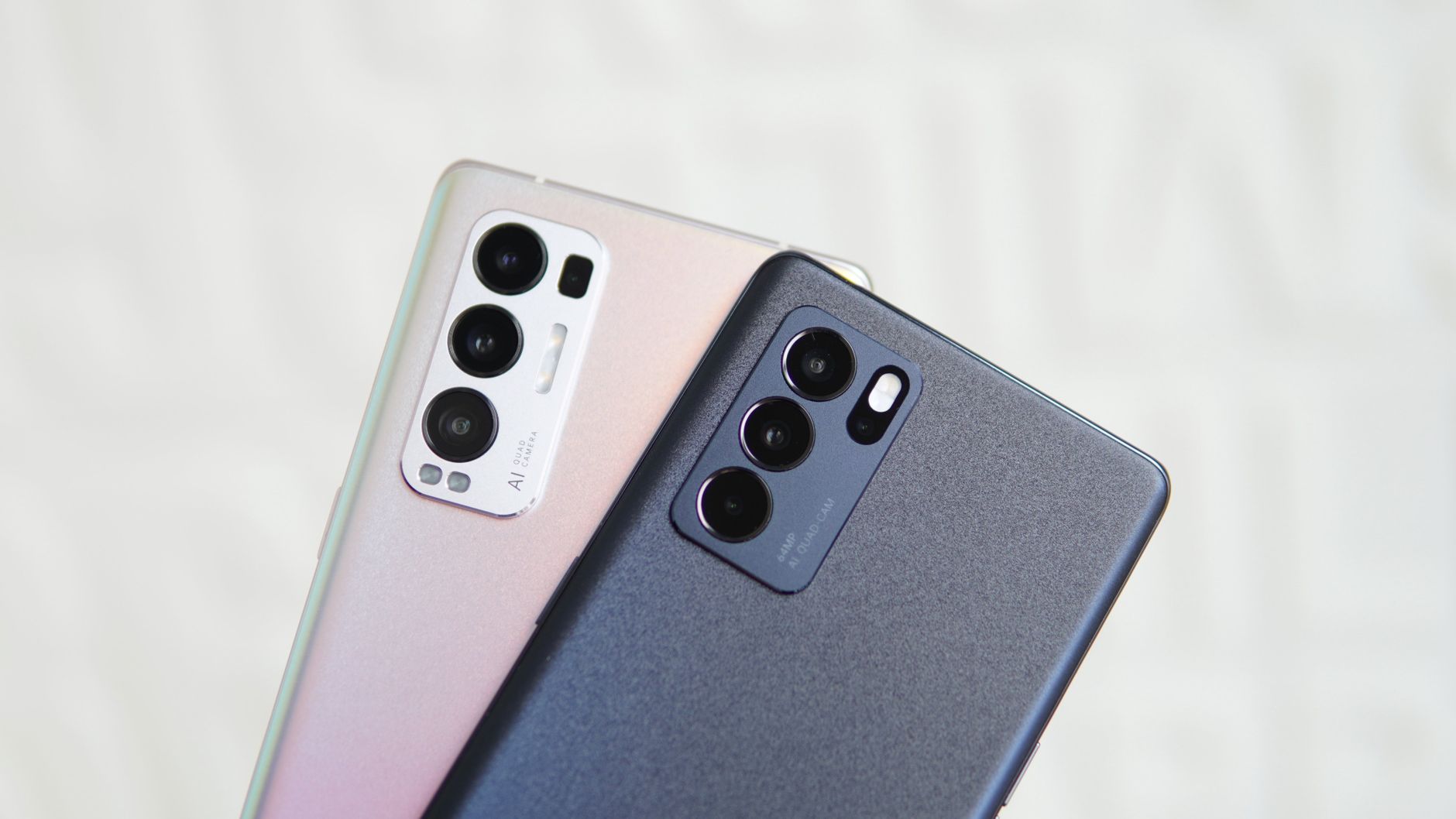 Close-up of two smartphones showcasing triple camera technology in modern design.