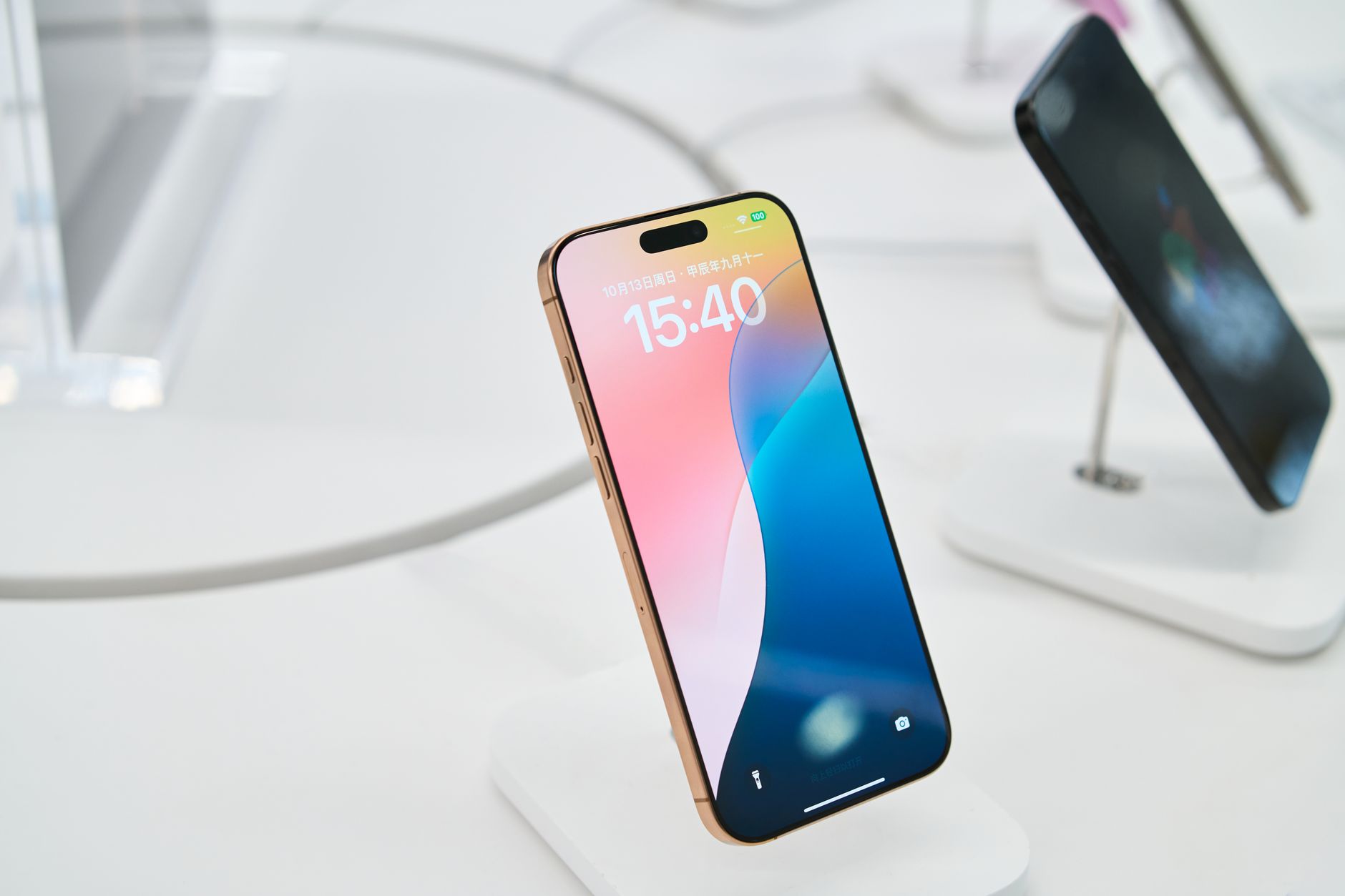 Close-up of a stylish smartphone in a tech showroom, highlighting its sleek design.