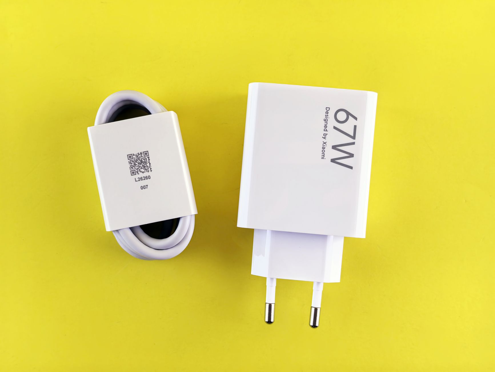 67W charger and cable set on a vibrant yellow background, showcasing charging technology.