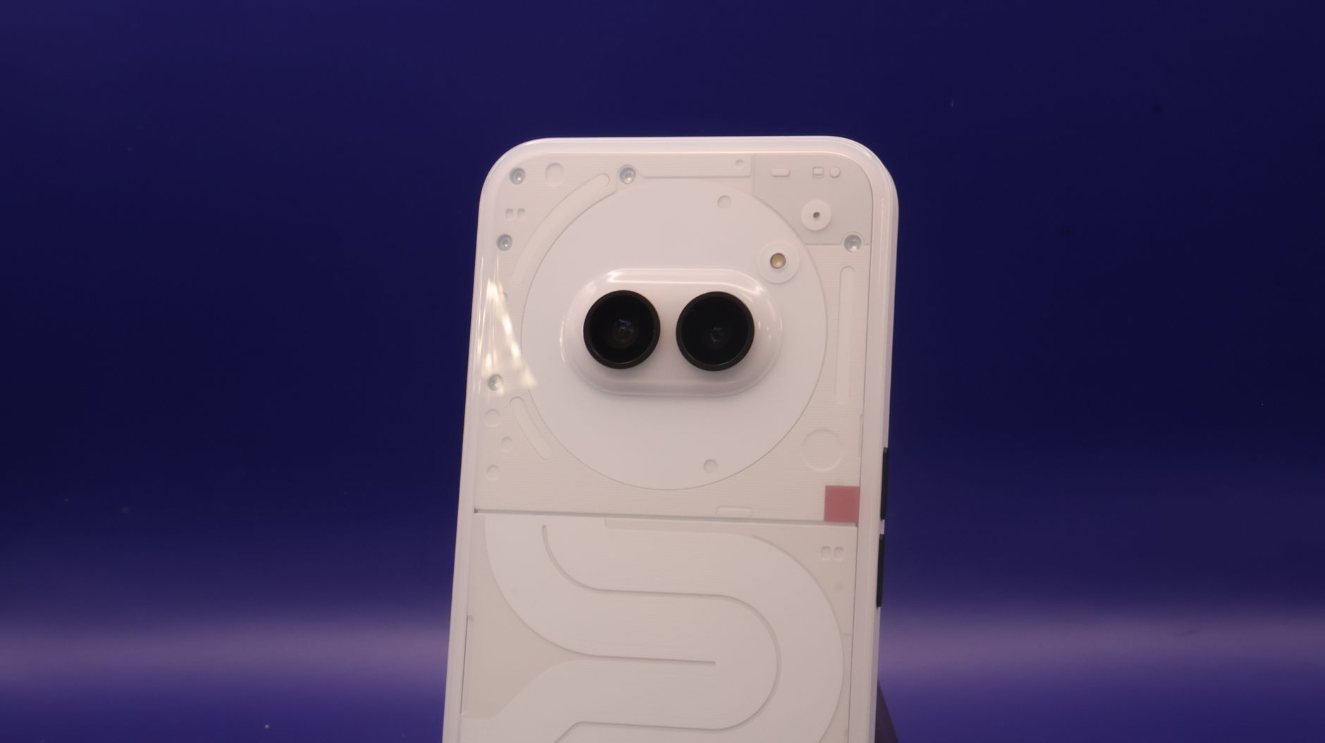 A sleek smartphone with dual cameras against a vibrant blue background.