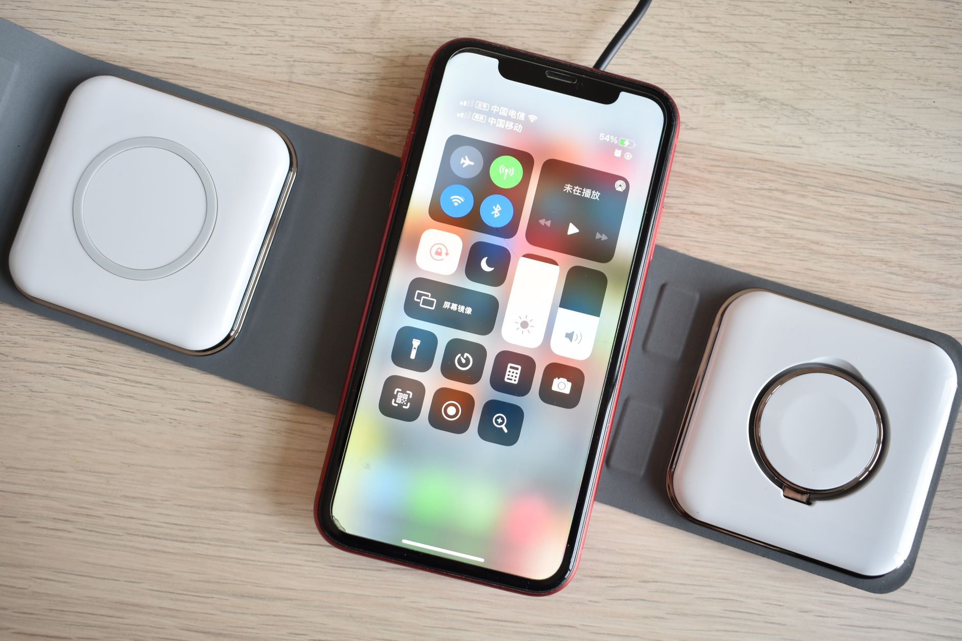 Top view of a smartphone using advanced wireless chargers, showcasing contemporary technology.