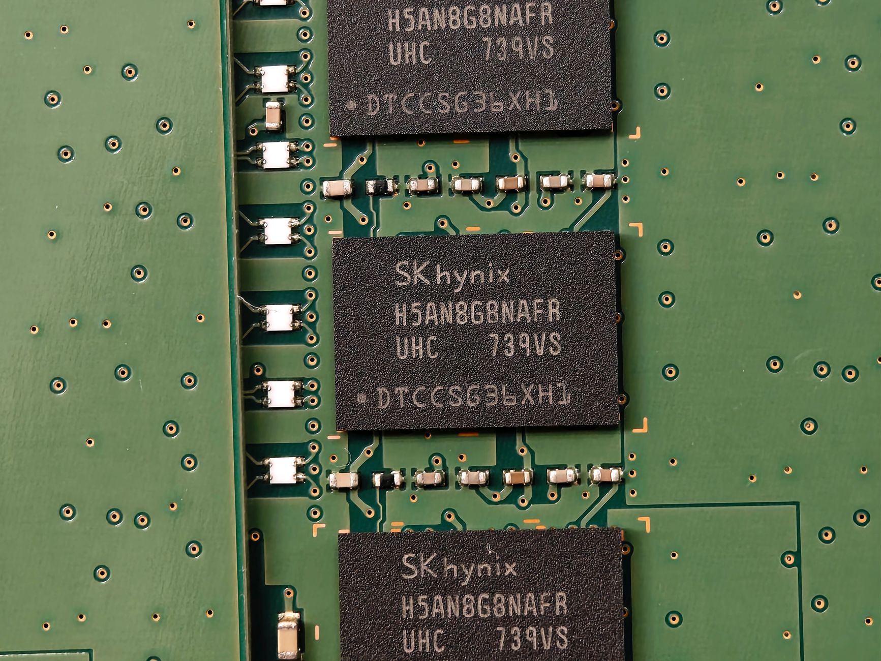 Detailed view of SK hynix DRAM chips on a green circuit board featuring electronic components.