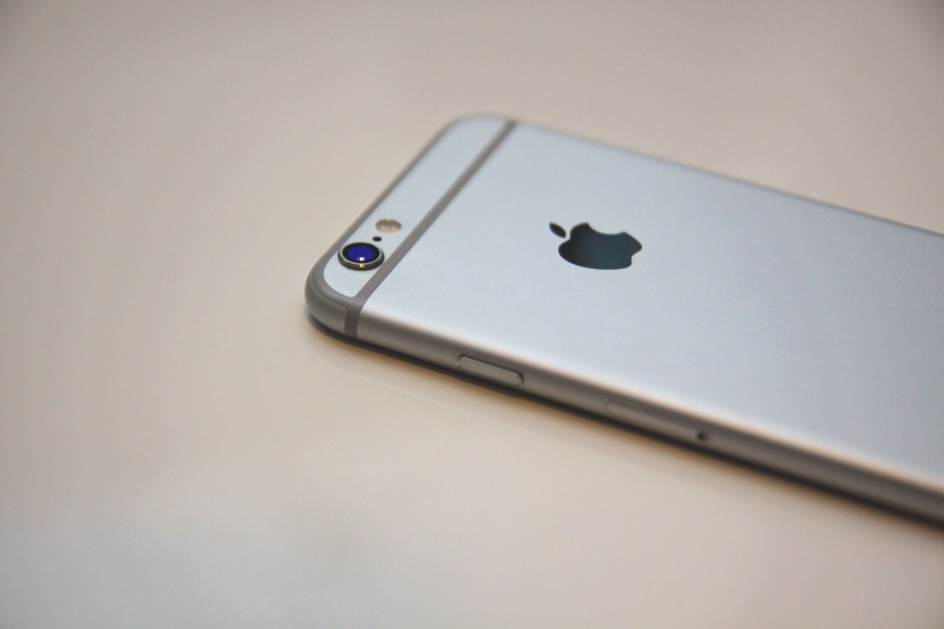 Closeup of silver smartphone showcasing camera and logo, perfect for technology and lifestyle themes.